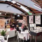 Exhibition booth with customers and jewelry display cases