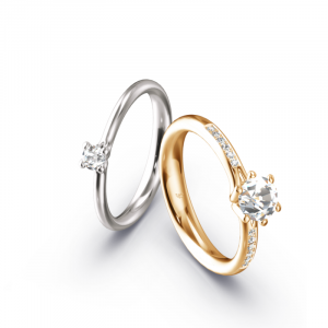 Zwei Eheringe aus Weißgold und Apricotgold mit Brillanten