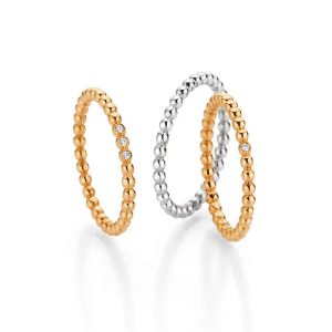 Wedding rings in yellow gold and white gold with faceted diamonds and pearl effect, made in Germany