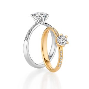 Wedding rings in white gold and yellow gold with solitaire diamonds and diamond setting ring, individually combinable from Fischer Trauringe