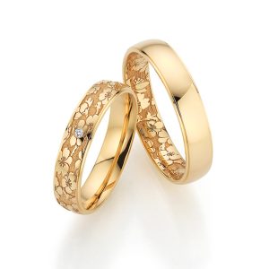Engraved apricot gold wedding rings with diamonds