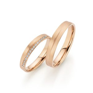 Two apricot gold wedding rings with diamonds